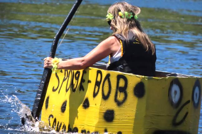 A competitor in her cardboard boat at the 2025 regatta.