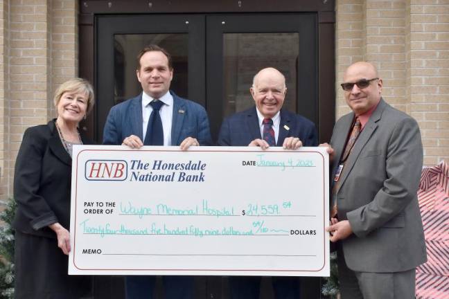 Pictured left to right: Lisa Champeau, director of Wayne Memorial Health Foundation/Wayne Memorial Hospital (WMH) Communications &amp; Development; Charlie Curtin, HNB VP and Trust Officer; Paul Meagher, Co-Trustee, WMH CEO; James Pettinato, RN, MHSA, CCRN-K.