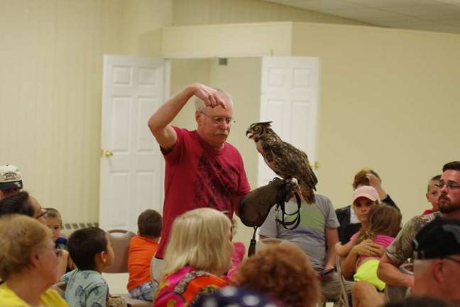 Delaware Valley Raptor Center Director William Streeter with Harley, a great horned owl. (Photo by George Leroy Hunter)