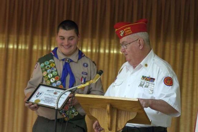 Eagle Scout Joseph P. Loughney III holds a certificate of recognition from the Marine Corps League (North Shore Queens Detachment, NYC) presented by member Thomas F. Mahe (Photo by George Leroy Hunter)