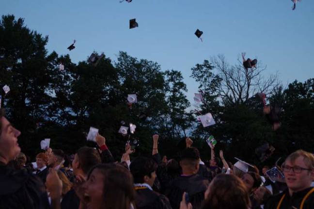 Delaware Valley High School graduates toss their caps.