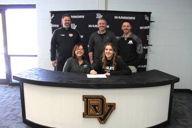 Sasha Sheehan commits to playing soccer at Lesley University. Front row (L-R): Felicia Sheehan and Sasha Sheehan. Back row (L-R): Club coach Derek Eversdyke, assistant coach Jeff Luhrs, and head coach Kevin Quinn.