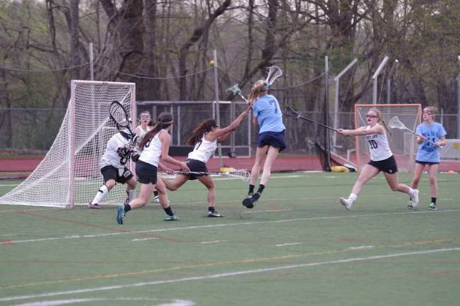 Wyoming's Abby Straub (7) fires the ball towards the goal post as Delaware Valley defends