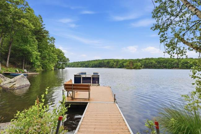 Upscale modern lakefront has private dock, media room and home gym