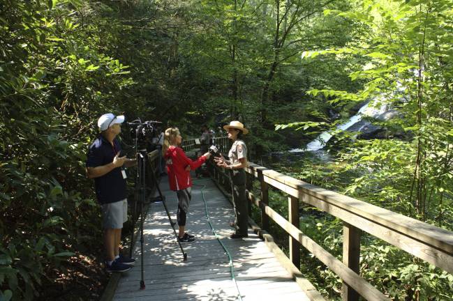 Kathleen Sandt, Public Information Officer, talks to journalists at the bottom of the falls (Photo by Pamela Chergotis)