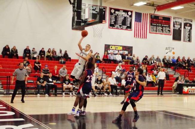 Delaware Valley's Tyler Smith raises the ball towards the hoop. Smith scored fourteen points.