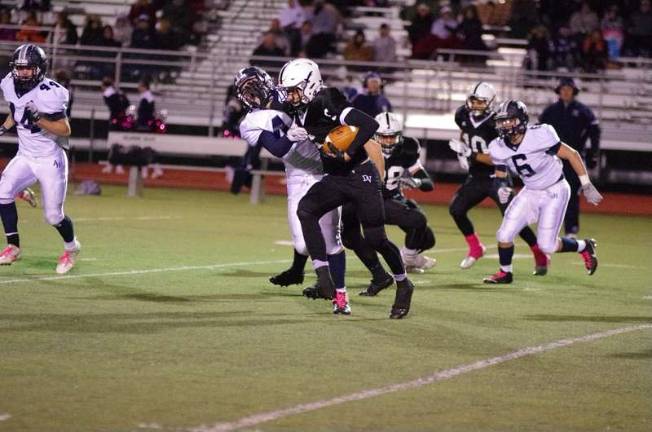 Delaware Valley ball carrier Tyler Smith stiff arms Abington defender Adam Wellard in the first half (Photo by George Leroy Hunter)
