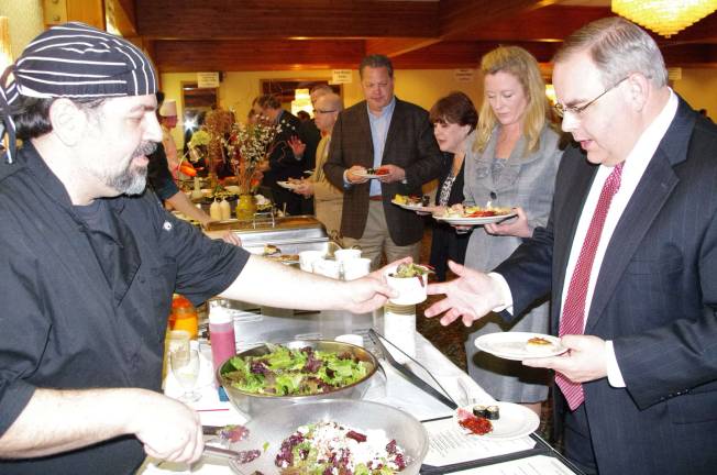 At the 2014 &quot;Chefs Do Dinner,&quot; River Rock Chef Ken Pisciotta serves a guest (Photo by George Leroy Hunter)