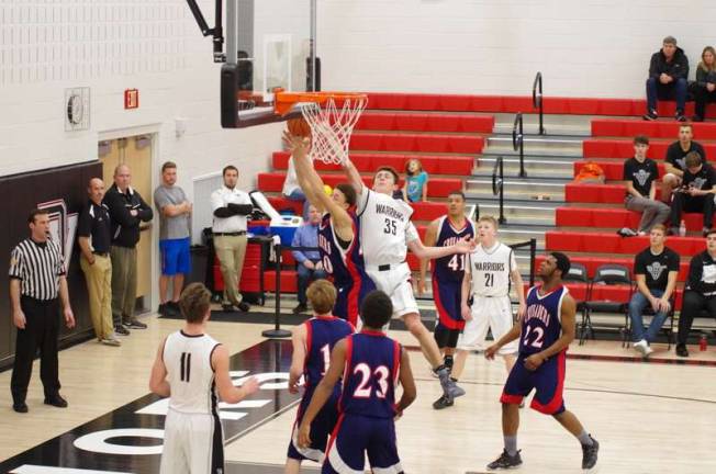 The shot attempt of Coughlin's Julius Morris is blocked by Delaware Valley's Shane Acoveno #35.