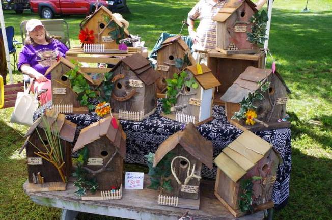 Newfoundland, Pa., artist Stephanie Spotts is pictured behind the display of birdhouses she made from wood and repurposed materials. Spotts works out of her studio, SAS Design.