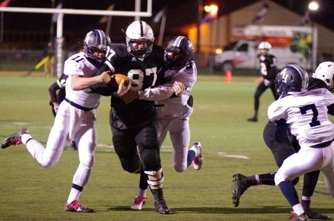 Delaware Valley tight end Brendan Heaney (87) is confronted by a pair of Abington defenders in the first half (By George Leroy Hunter)