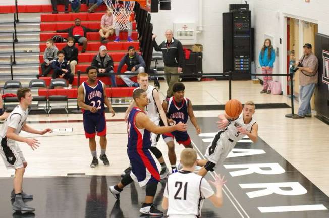 As he falls Delaware Valley's Tyler Smith passes the ball to teammate Blake Gearhart #21.