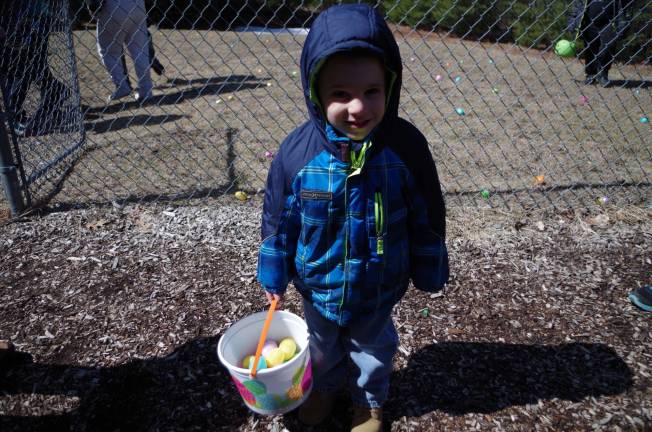 Three year old Thomas Height of Dingmans Ferry and his bucket of Easter eggs.