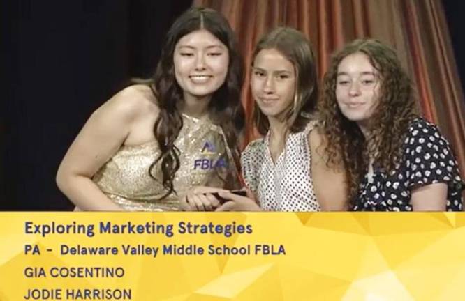 Gia Cosentino and Jodie Harrison of the Delaware Valley Middle School FBLA accept their award in the category of exploring marketing strategies.