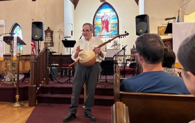 Dave Matsinko showing the Gourd Banjo to audience at GHTA’s Lunch and Learn on April 18.