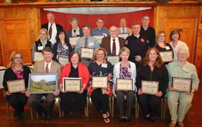 Seated (from left): Palmira Miller, coordinator of the Pennsylvania Environmental Council’s Community Illegal Dumpsite Clean-up Program, Community Service Award (organization); U.S. Congressman John J. Faso (NY-19), keynote speaker; Elaine Giguere, Delaware Valley Arts Alliance executive director, Cultural Achievement Award; Debra Conway, Revitalizing the Monarch Butterfly brochure coordinator, Partnership Award; Vanessa DeGori of the Milanville General Store, Community Service Award (individual); Connie Lloyd, 34-year National Park Service Interpretation Ranger retiree, Special Recognition Award; and Carol Henry Dunn, Wayne County Historical Society executive director, Cultural Achievement Award (organization). Second row: LouAnn Joyce and Tina Spangler, “Tusten’s Colorful History” book, Special Recognition Award; Scott Rando of Shohola, PA, Volunteer Award; John Kerkowski and Al Petrillo of the Lackawaxen Township Fire Commission for “Operation Safe River”, Recreation Achievement Award; Dorene Warner of W. Design, Monarch Butterfly brochure, Partnership Award; and Janet Sweeney, vice-president of Pennsylvania Environmental Council. Top row: Fred Peckham, Town of Hancock, 2016 UDC chairman, Oaken Gavel Award; Lauren Schlagenhaft, “Tusten’s Colorful History”; Glenn Pontier, Upper Delaware Scenic Byway chair, Partnership Award; Jeff Haas, Town of Highland supervisor, Partnership Award; and Tom Colbert, Wayne County Historical Society Board of Trustees. Absent were Distinguished Service Award honoree Ed Wesely of Milanville, Pa.; Robin M. Daniels Memorial Lifesaving Award honoree Michael K. Smith of Point Pleasant, N.J.; and Public Service Award honoree Chris Gibson, 2010-2016 U.S. Congress 19th District-New York. (Photo provided)