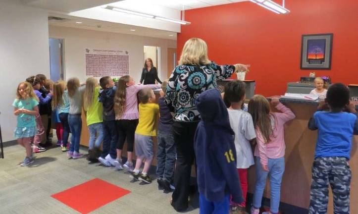 Mrs. Stewart’s class in the office (Photo by Peg Snure)