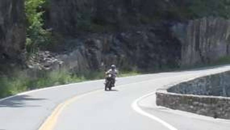 A motorcyclist drives on Route 97 in Hawks Nest. Photo by Ana Tikka.