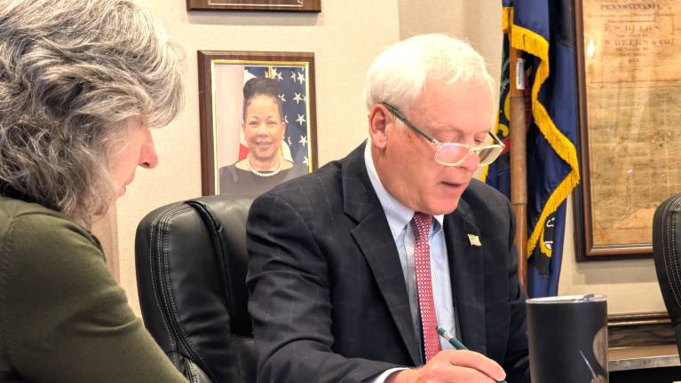 Commissioner Ron Schmalzle reads from the agenda.