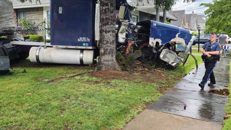 A damaged 2016 Freightliner comes to a rest after wreaking havoc and killing one in Milford July 29.