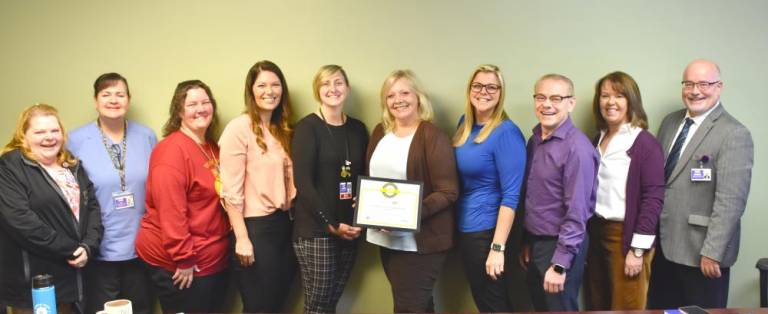 L-R: Michelle Corrigan, RN, clinical care coordinator/risk manager; Jo-Ann Sames, RN, supervisor, Forest City Family Health Center; Jennifer Allison, LPN, practice manager, pediatric services; Christina MacDowell, CNM, DNP, practice manager, Women’s Health Center; Kara Poremba, MSHA, BSN, chief quality officer; Erica Brown, chief development officer; Wynter Newman, chief administrative officer; James Cruse, MD, chief medical officer; Teresa Lacey, RN, CEO; and Robert Fortuner, CFO.