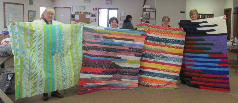 Pictured at the guild's recent Quilt Day with their finished tops are (from left): Nancy Holleran, Carol Lawrence, Cheryl O'Sullivan and Marie Sanduer (Photo provided)