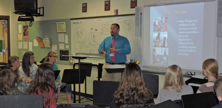Musician Rick Bullock with students Autumn Baker, Samantha Garcia, and Olivia Gandolfo (Photo provided)