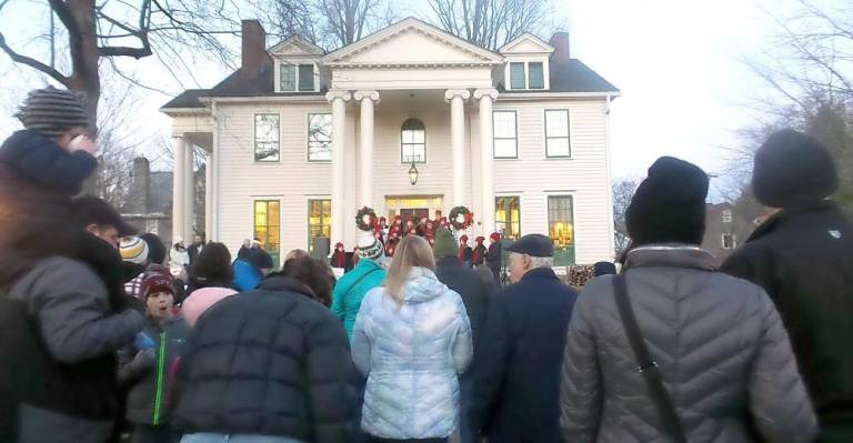 People packed the Community House grounds to listen to carols, drink hot chocolate, munch on cookies, greet Santa, and watch the tree come to life. (Photo by Frances Ruth Harris)