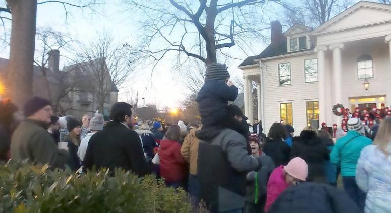 People packed the Community House grounds to listen to carols, drink hot chocolate, munch on cookies, greet Santa, and watch the tree come to life. (Photo by Frances Ruth Harris)