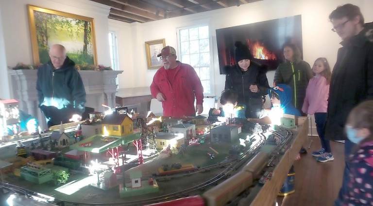 The magical antique train display, courtesy of Tom Keegan, captivated young and old alike, especially the engine that puffed smoke as it rounded the tracks. (Photo by Frances Ruth Harris)