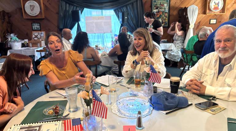 State Rep. Tarah Probst in orange next to Lisa Miller, her legislative assistant, at the Margaret Mary Memorial Scholarship Dinner.