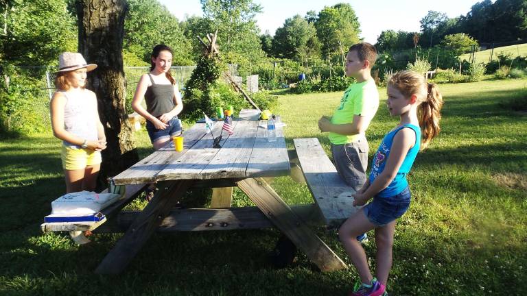 Hannah Williams, Ava Nienstadt, Aidan Fitzpatrick and Peyton Fitzpatrick before their lesson of foods that grow as roots, on trees, on the ground, and on vines (Photo by Frances Ruth Harris)