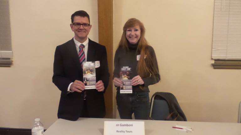 Pike County Coroner Christopher Brighton and Reality Tour Director Jill Gamboni showcasing the next Reality Tour in Milford at the Milford Bible Church on Nov. 19 (Photo by Frances Ruth Harris)
