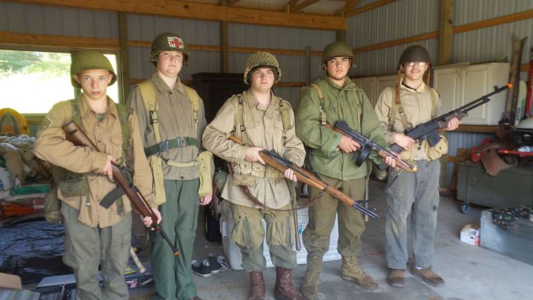Matthew Bailey, Andrew Phillips, Ronald Syme, Terrance Ring and Mark DeBlock standing inside one of the out buildings on Scout Master Carol Phillips' property. The building is used for costume and property storage during filming (Photo by Frances Ruth Harris)