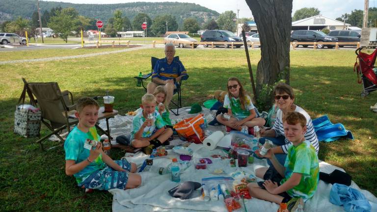 The O'Sullivans enjoying the eclipse party picnicking. In the photo are grandad Brendan and grandma Cheryl, and kids from the left: Caleb, Connor, Keira, Devon, and Trey Garutti.