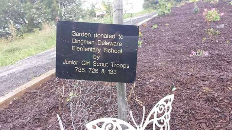 A sign gives credit to the contributon of three local Junior Girl Scout Troops (Photo provided)