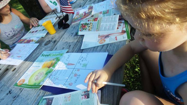 4H gardeners complete work sheets for their lesson (Photo by Frances Ruth Harris)