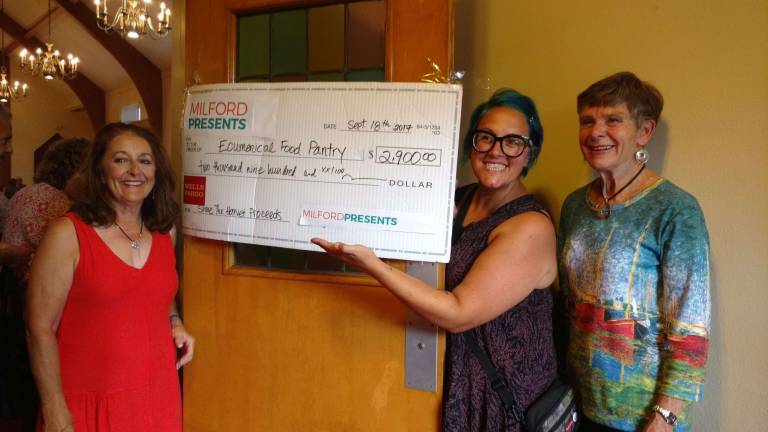 Amy Eisenberg (holding check), Milford Presents' executive director, with two other volunteer organizers at Share the Harvest (Photo by Anya Tikka)
