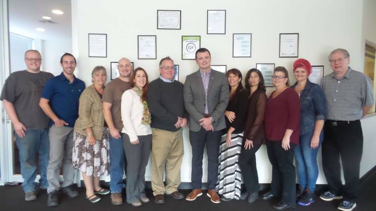 Some of the members of the Econo-Pak team (from left): Maintenance Manager Adam Launsbury, Production Manager Johnny Montana, Billing Specialist Ilene Fenigan, Shipping and Receiving Manager Rich Kleh, Customer Service Donna Lounsburg, Chief Operating Officer Ed Horn, Chief Executive Officer PJ Wiebel, Customer Service ManagerWendy O’Brien, Customer Service Tara Puhlovsky, Customer Service Shelly Rhinesmith, Quality Control Manager Debbie Meerdink, Director of Quality Jim Keenan (Photo by Frances Ruth Harris)