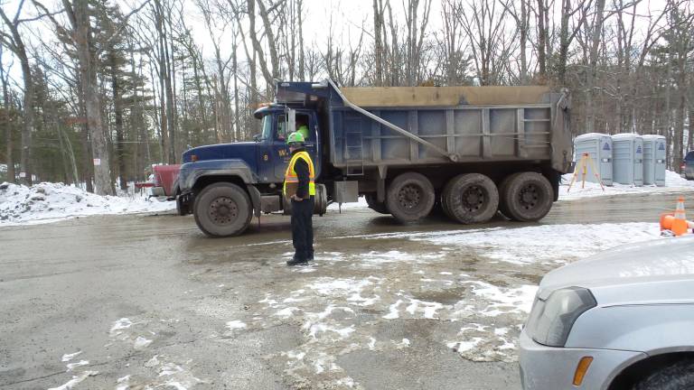Dump trucks and delivery trucks swarm the compressor site (Frances Ruth Harris)