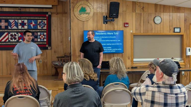Taylor Meise (left) and Aaron Feingold speak to concerned residents about the Shawnee-Walker project at Stop FirstEnergy gathering.