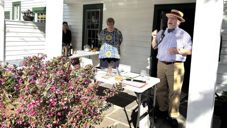 Left to right Carol McManus and Brian Carso (co-chairs of MRAW ) addressing guests on porch of John Wallace house in Milford