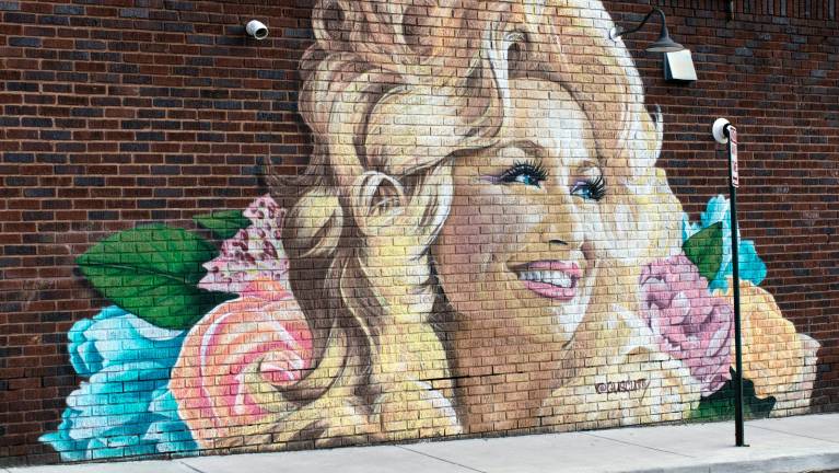 You could find this artwork of Dolly Parton on Haywood Road in West Asheville, N.C. Photo by Wes McFee on Unsplash.