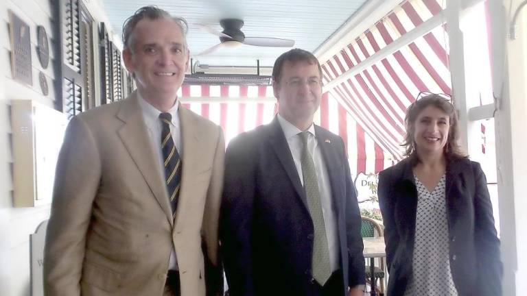 From left: Milford Mayor Sean Strub, German Consul General David Gill and his wife, Shelia, on the porch of the Hotel Fauchère on Tuesday (Photo by Frances Ruth Harris)