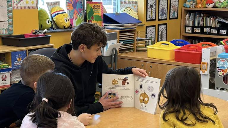 Delaware Valley High School freshman Blake Luhrs reads to the elementary students as part of a National Read Across America Day program. Photos provided by Leslie Lordi/Delaware Valley High School.