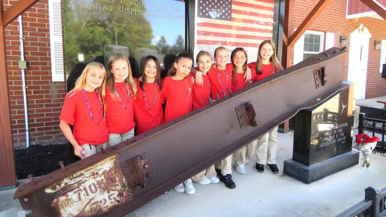 The reporters outside by an actual beam from the Twin Towers.