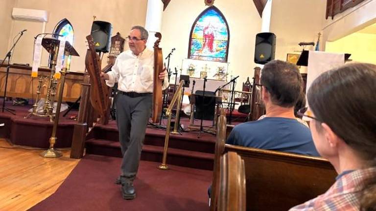 Dave Matsinko shows two Appalachian Mountain Dulcimers to audience at GHTA’s Lunch and Learn on April 18.