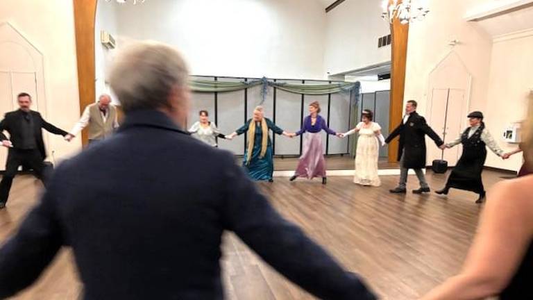 Attendees participate in a Regency-era dance at the Hanna Q Dance Company ball.