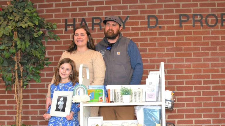 Ella, Katie and Cody Yedinak with a picture of Hudson John.