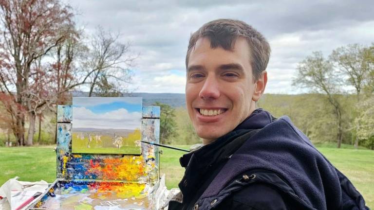 Artist Mitchell Saler with his landscape.